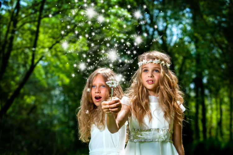 Fantasy portrait of cute girls with magic wand in forest.